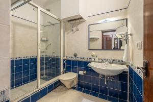 a bathroom with a sink and a shower and a toilet at ama Stays & Trails Skanda , Coorg in Madikeri +62 photos