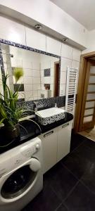a bathroom with a sink and a bath tub at Apartament Perłowy 2 - z antresolą i widokiem - Dream Apart in Ustroń