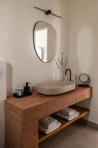 a bathroom with a large sink and a mirror at Nysis Koufonisia in Koufonisia
