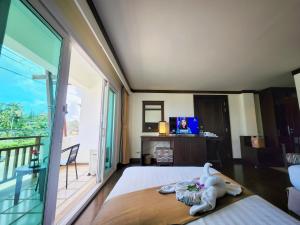 a bedroom with a bed and a large window at Lanta Mermaid Boutique House in Ko Lanta