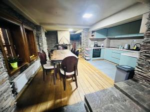 a kitchen and dining room with a table and chairs at Luxury Villa Medusa Temple in Kruševo