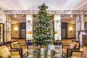 a christmas tree in the lobby of a hotel at Esplanade Zagreb Hotel in Zagreb