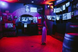 a woman standing in a room with a red light at YellowSquare Rome in Rome