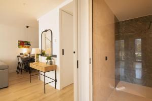 a bathroom with a walk in shower next to a table at Riverview apartamento en LLanes in Llanes +29 photos