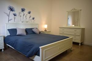 Schlafzimmer mit einem Bett, einer Kommode und einem Spiegel in der Unterkunft MarcoPoloAirport-2 camere da letto-Wifi-Netflix-15' da Venezia in Tessera