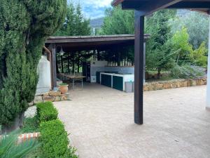 a pavilion with a kitchen in a garden at Villa al Presti, Vacanze in pieno relax in Cefalù