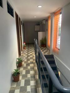 a hallway with stairs and potted plants in a building at MSG LODGING HOME in Puerto Princesa City