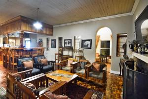 a living room filled with lots of furniture at Zuurberg Mountain Village in Addo