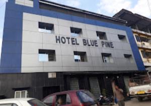 un hotel de pino azul con coches estacionados frente a él en Hotel Blue Pine Arunachal Pradesh, en Itānagar