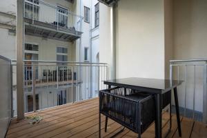 a black table on the balcony of a building at Stylish central 1-bedroom apartment with a terrace in Vienna