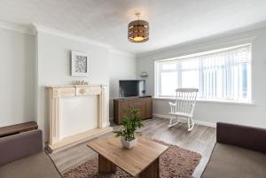 a living room with a couch and a table at Wealcroft House - Charming 3-Bedroom in Wealcroft in Felling
