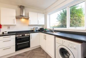 a kitchen with a sink and a dishwasher at Wealcroft House - Charming 3-Bedroom in Wealcroft in Felling