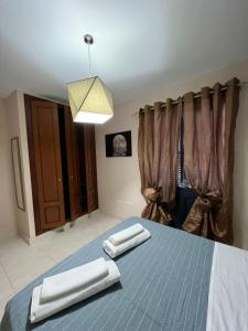 a bedroom with a bed with two towels on it at Villa Margherita in Playa Blanca