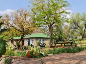 a house with a picnic table and a bench at Tshifaro Gardens in Thohoyandou