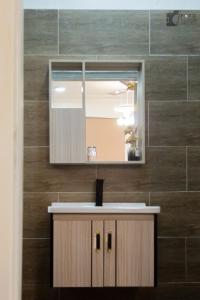 a bathroom with a sink and a mirror at SUCCESS ROSE - East Legon, Adjiringanor in Accra