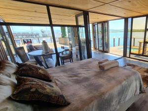 a large bed in a room with a view of the water at Tshifaro Gardens in Thohoyandou +55 photos