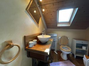 a bathroom with a sink and a toilet at Moura in Labastide-Villefranche