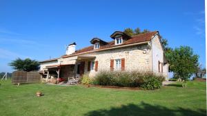 an old stone house on a field of grass at Moura in Labastide-Villefranche