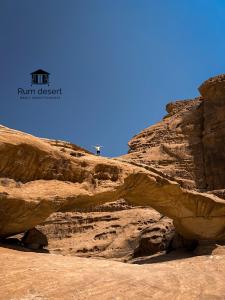 a person standing on top of a rock cliff at Rum desert magic in Wadi Rum