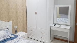 a bedroom with a white cabinet and a mirror at CH Mường Thanh Luxury 60 Trần Phú. Nha Trang in Nha Trang