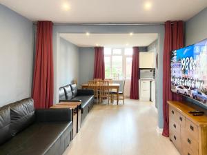 a living room with a couch and a dining room at Castle View in Stafford