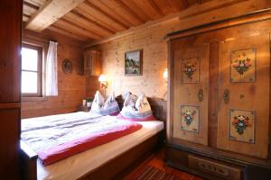 a bedroom with a bed in a wooden cabin at Almliesl GAST-462 in Bad Hofgastein