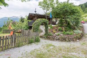 a garden in front of a house with a fence at Almliesl GAST-462 in Bad Hofgastein