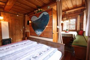 a bedroom with a bed with a heart on the wall at Almliesl GAST-462 in Bad Hofgastein