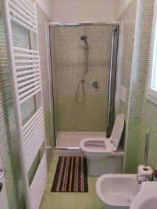 a bathroom with a shower and a toilet and a sink at Signora Ruth - Aprilia Residence in Aprilia Marittima