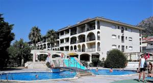 a large building with a slide in front of a swimming pool at JARDINS DEL MAR 25 in L'Estartit