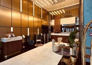 a lobby with a person sitting at a counter at Maslak Aparts in Istanbul
