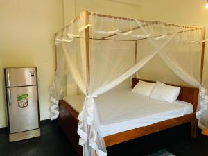 Postel nebo postele na pokoji v ubytování Villa Don Williams Weligama