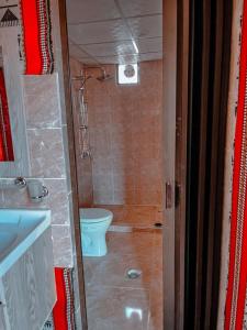 a small bathroom with a toilet and a sink at Star rum in Wadi Rum