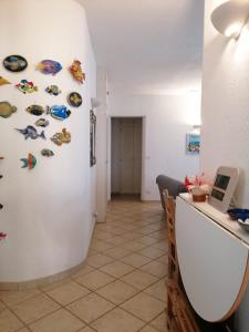 a hallway with a white wall with fish magnets at Costa dei Monaci Villas - Tropea in Parghelia