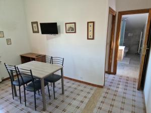聖切薩雷奧的住宿－Appartamento nella campagna romana，一间带桌椅和电视的用餐室