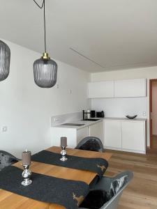 a kitchen with a table and chairs in a room at Cosy Apartment Marlain-Self Check in in San Valentino alla Muta