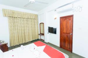 a room with a door and a red rug at The Ocean Pearl Resorts in Panadura