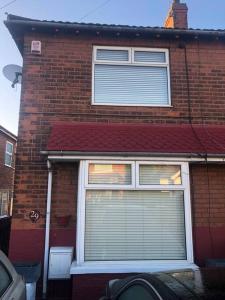 a brick house with a window with blinds on it at 29 Comfort house 2 bedroom townhouse with parking in Scunthorpe