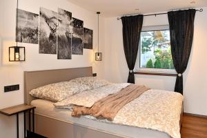 a bedroom with a bed and a window at Appartement Edelschwarz in Westendorf