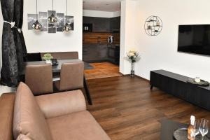 a living room with a couch and a table at Appartement Edelschwarz in Westendorf