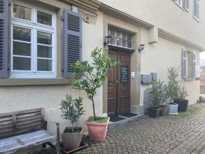 een gebouw met een deur en een bank ervoor bij Gästezimmer an der Stadtmauer in Besigheim