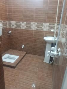 a bathroom with a toilet and a sink at Jinnah inn Guest House in Karachi