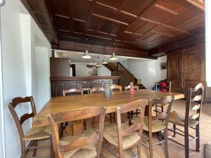 a dining room with a wooden table and chairs at Saint marty in Montory