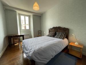 a bedroom with a large bed and a table at Saint marty in Montory