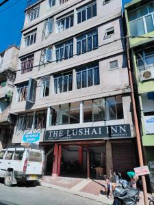 a building with a sign for the official inn at The Lushai Inn, Aizwal in Āīzawl
