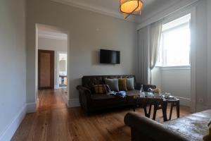 a living room with a couch and a table at Casa Portuguesa - Charming House in Ponta Delgada