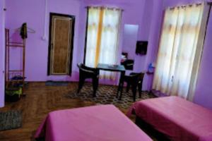 a purple room with a piano and a table at Chawngthu Lodge,Aizawl in Āīzawl