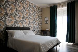 a bedroom with a bed with a floral wallpaper at Guest House Prime Palace in Rome