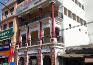 a building with a balcony on the side of it at Hotel Basera Odisha in Rourkela