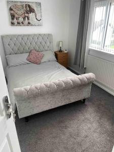 a bedroom with a bed with a elephant picture on the wall at 31 end terrace. in Whitehead